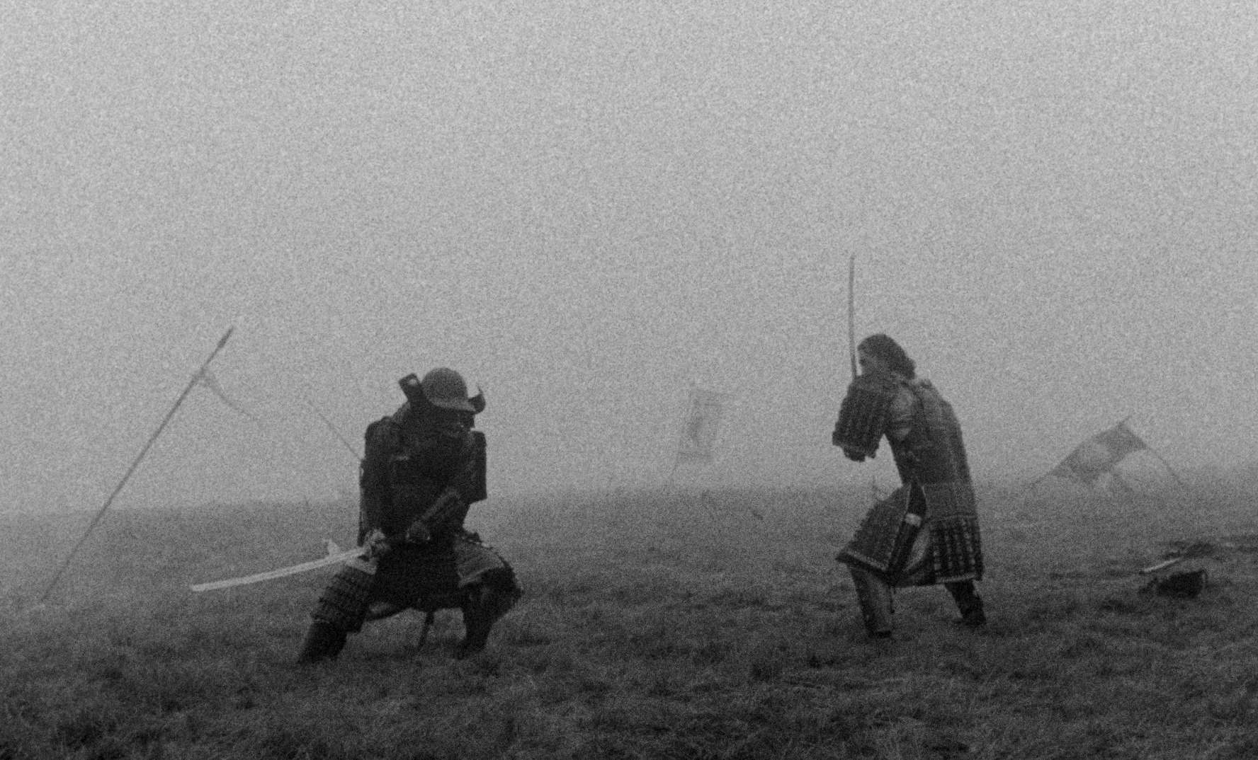 Two samurai in armour face each other with swords drawn on a misty field, in black and white.